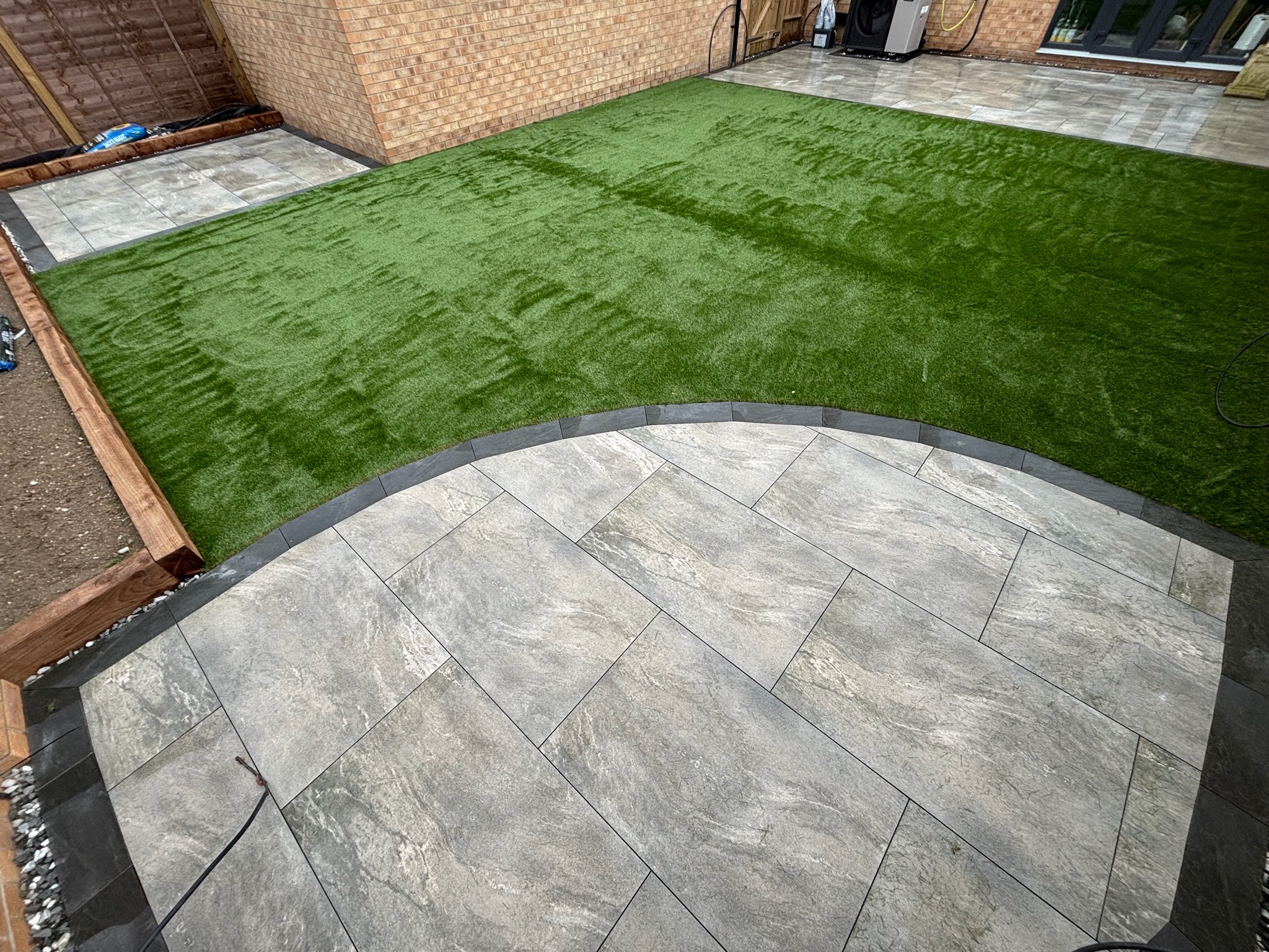 Earthcore Grey Porcelain Patios with Artificial Grass finished photo 2