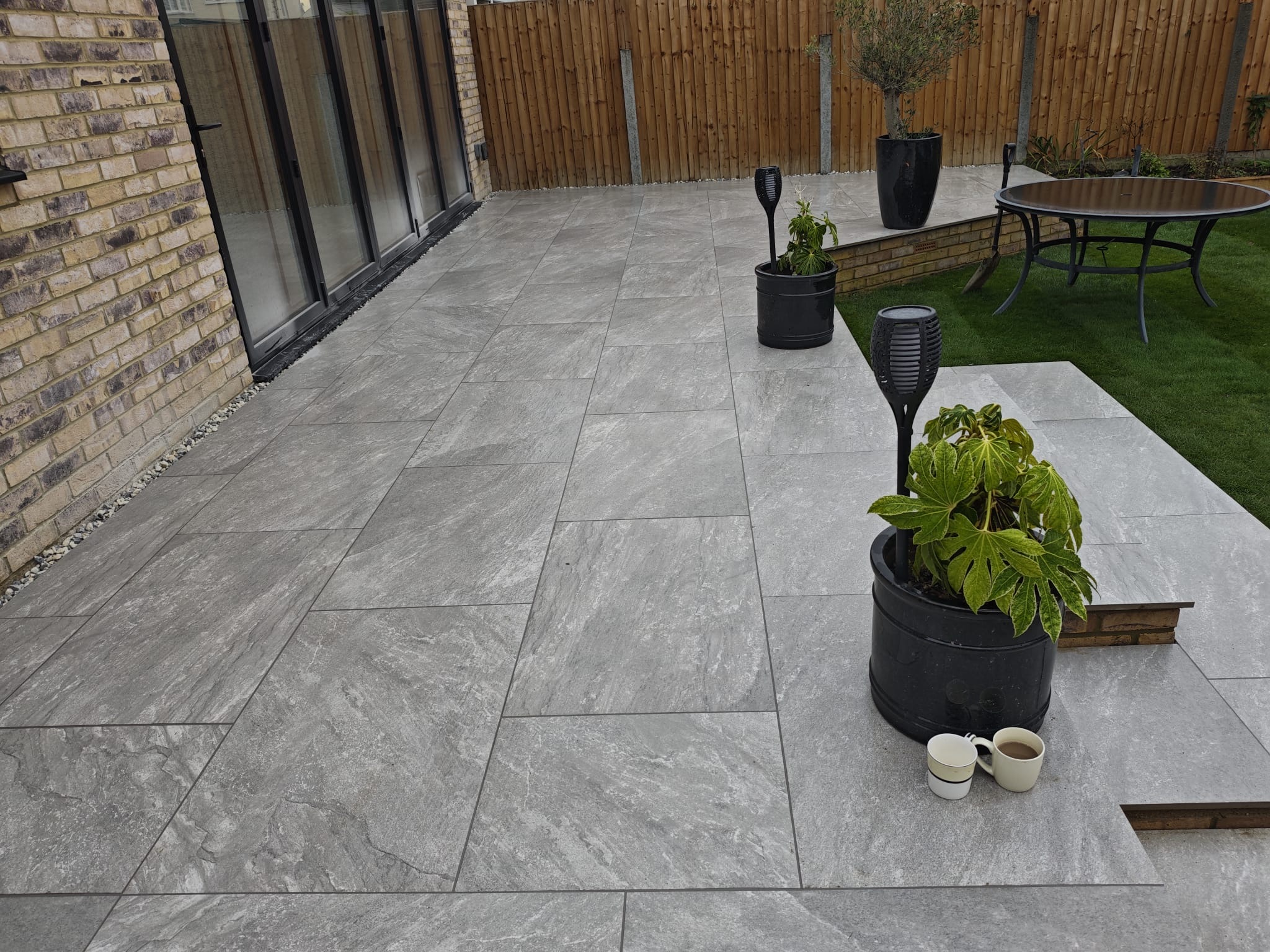 Earthcore Grey Porcelain Patio, Concrete Base, Artificial Grass & Rendered Wall