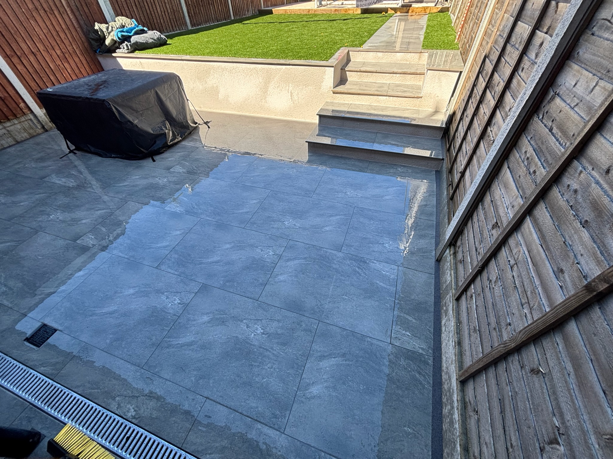 Earthcore Grey Porcelain Patio, Concrete Base, Artificial Grass & Rendered Wall finished photo 3