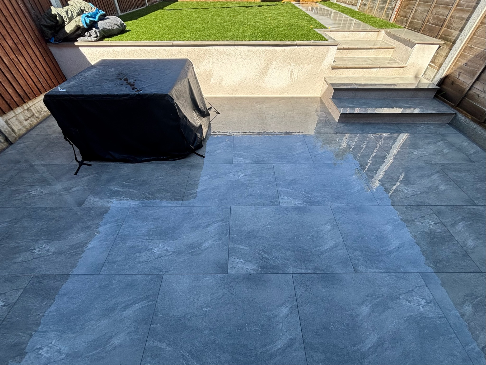 Earthcore Grey Porcelain Patio, Concrete Base, Artificial Grass & Rendered Wall finished photo 5