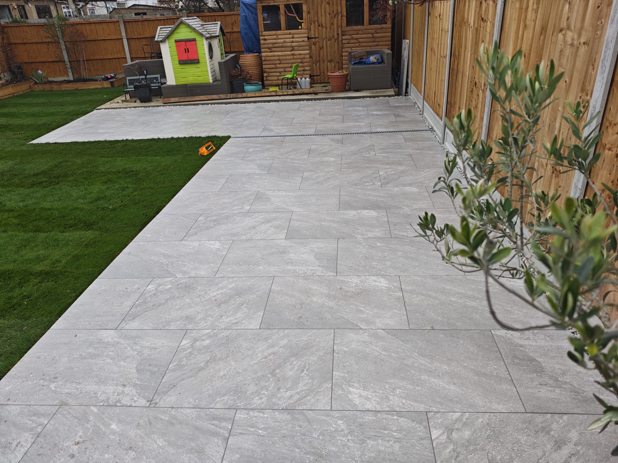 Earthcore Grey Porcelain Patio, Concrete Base, Artificial Grass & Rendered Wall finished photo 2